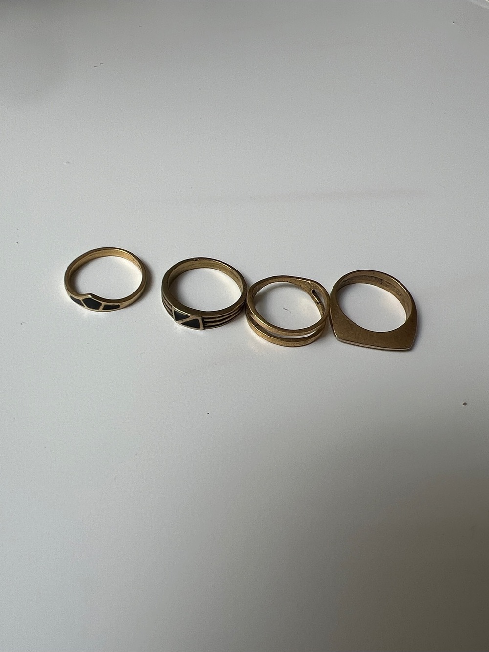 Set of 4 Gold Tone Stackable Rings with Black Enamel Accents